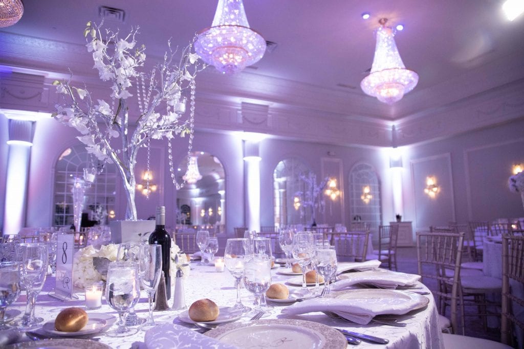 Valley-regency-wedding-venue-table-setting-and-backgrounnd-space-lit-with light-purple