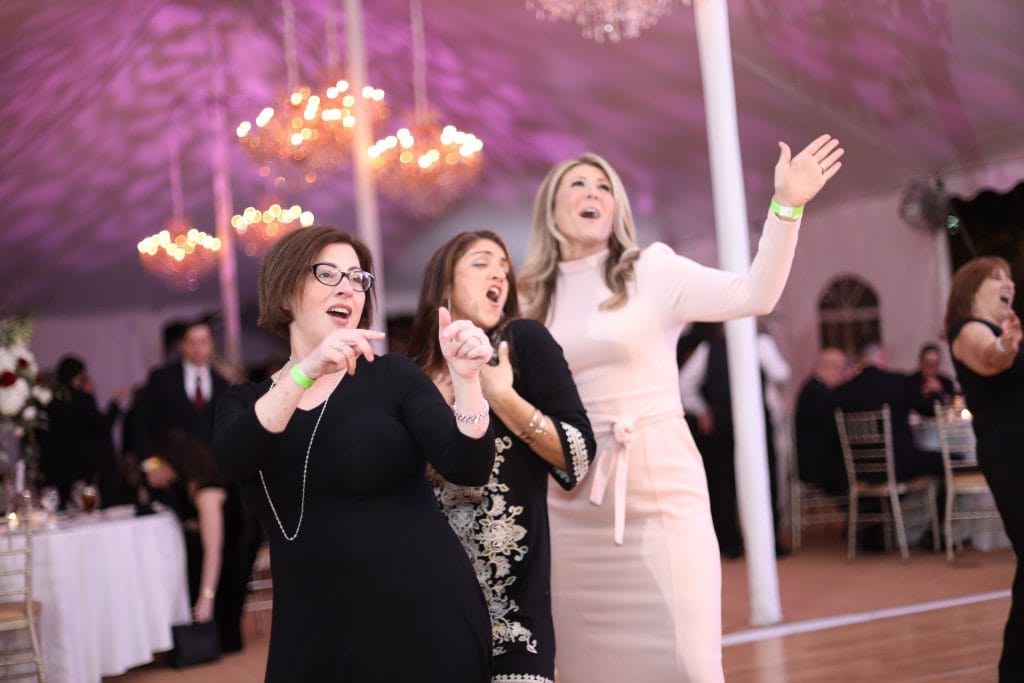 Femal wedding guest singing to together enthusiastically to wedding music and dancing - Wedding venue - The seasons Catering - washington township