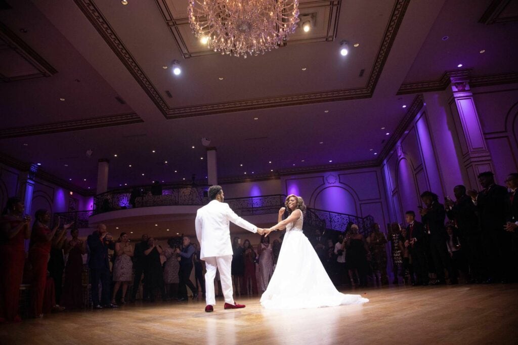 Black couple dancing under a spot light - The Tides Estate -Wedding Venue - Banquet Hall style