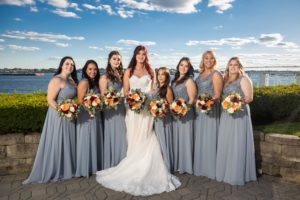 Bridesmaids-in-dusty-blue-brides-maid-dresses-standing-in-front-marina-del-rey-bronx