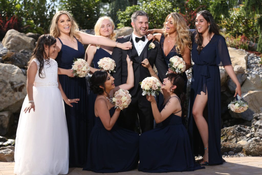 6-bridesmaids in-navy-blue-Bridesmaids-dresses-posing-with groom-in-fun-provacative-way