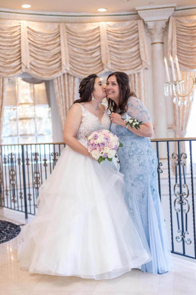 Plus-size White wedding dress and Curvy Bide and mother of the bride in blue dress posing on the balcony at the Tides Estates