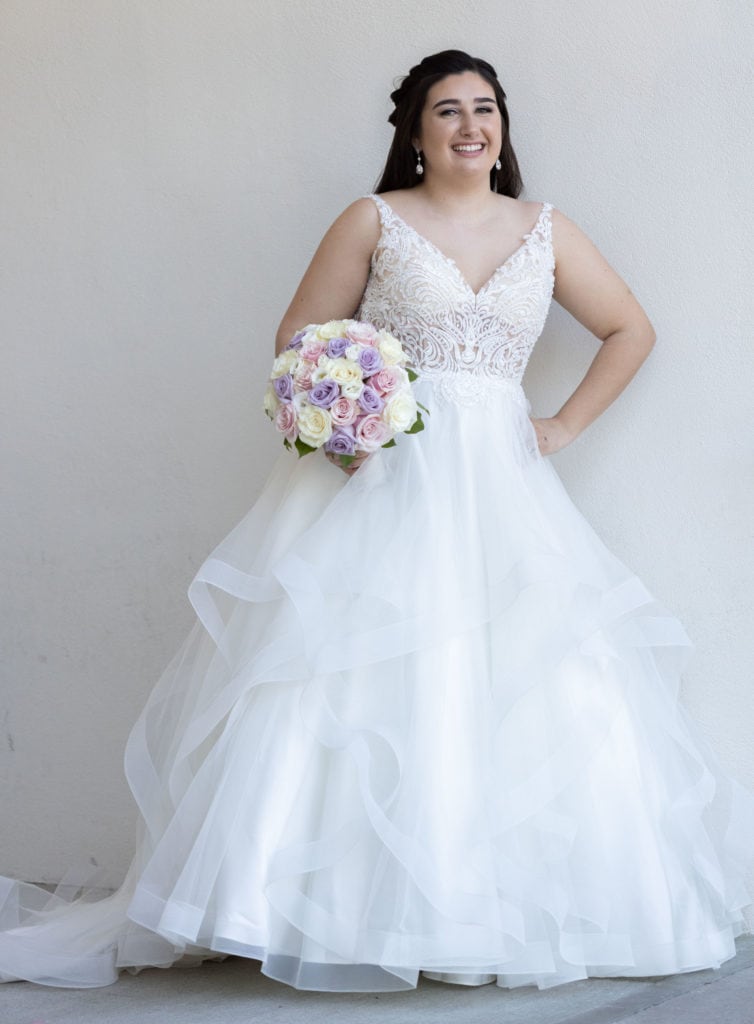 Plus-size White wedding dress and Curvy Bide posing outdoors at the Tides Estates