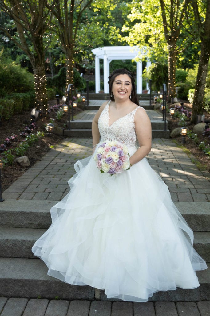 Plus-size White wedding dress and Curvy Bide posing in the outdoor gardens at the Tides Estate