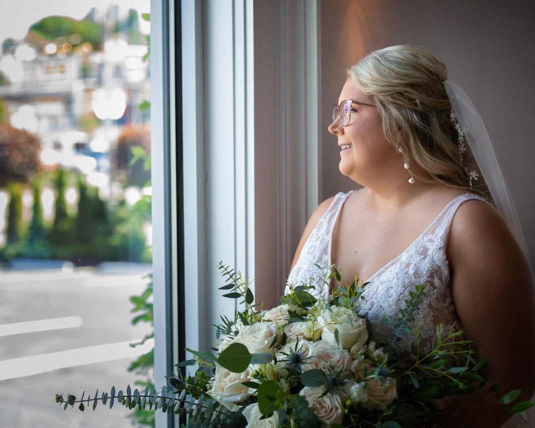 and standing in front well-lit soft window light of the The Banks - A Waterfront Venue - Wedding Veune