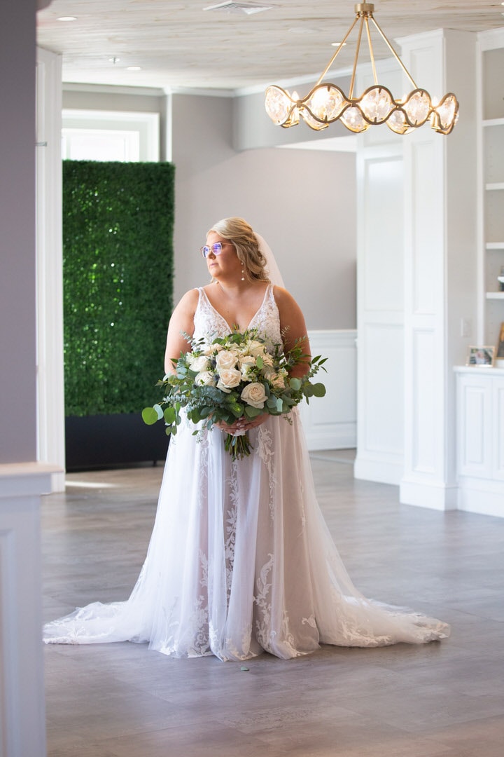 Plus-size Bride standing in the foyer of the The Banks - A Waterfront Venue - Wedding Veune