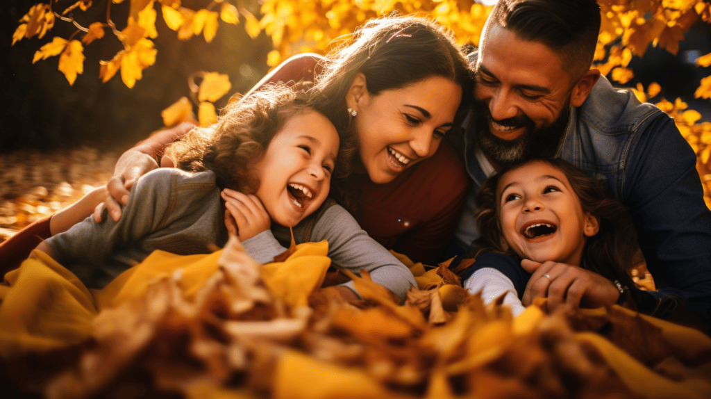 A heartwarming Pro Fall Latino Family Photoshoot with a family of four sitting on a cozy blanket surrounded by vibrant autumn leaves, golden sunlight filtering through the trees, capturing their genuine smiles and laughter, Portrait Photography, full - frame camera with a 35mm lens,