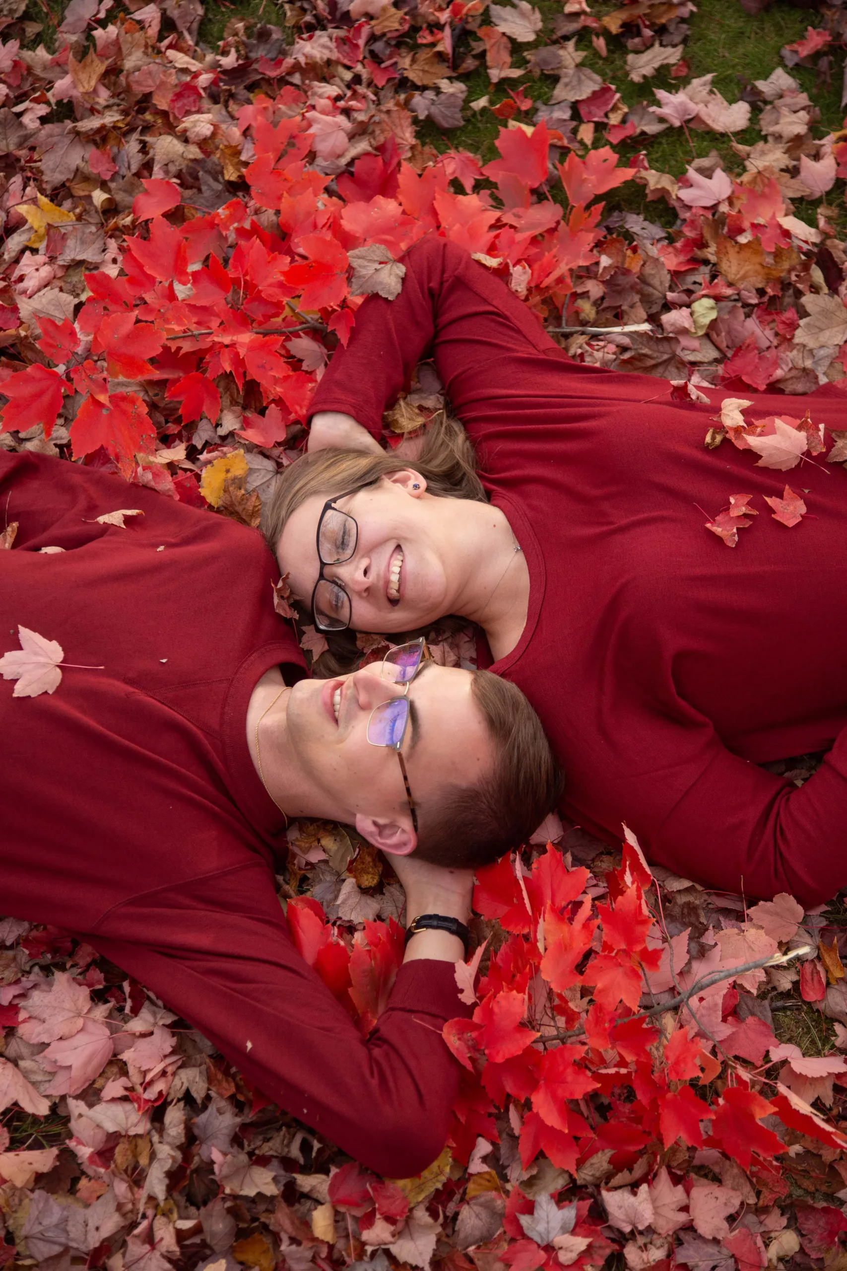 LightMaster-Studios-Website - engagement photos in Morristown NJ - Engaged coupled laying in the red autumn leaves - fall engagement session -9051